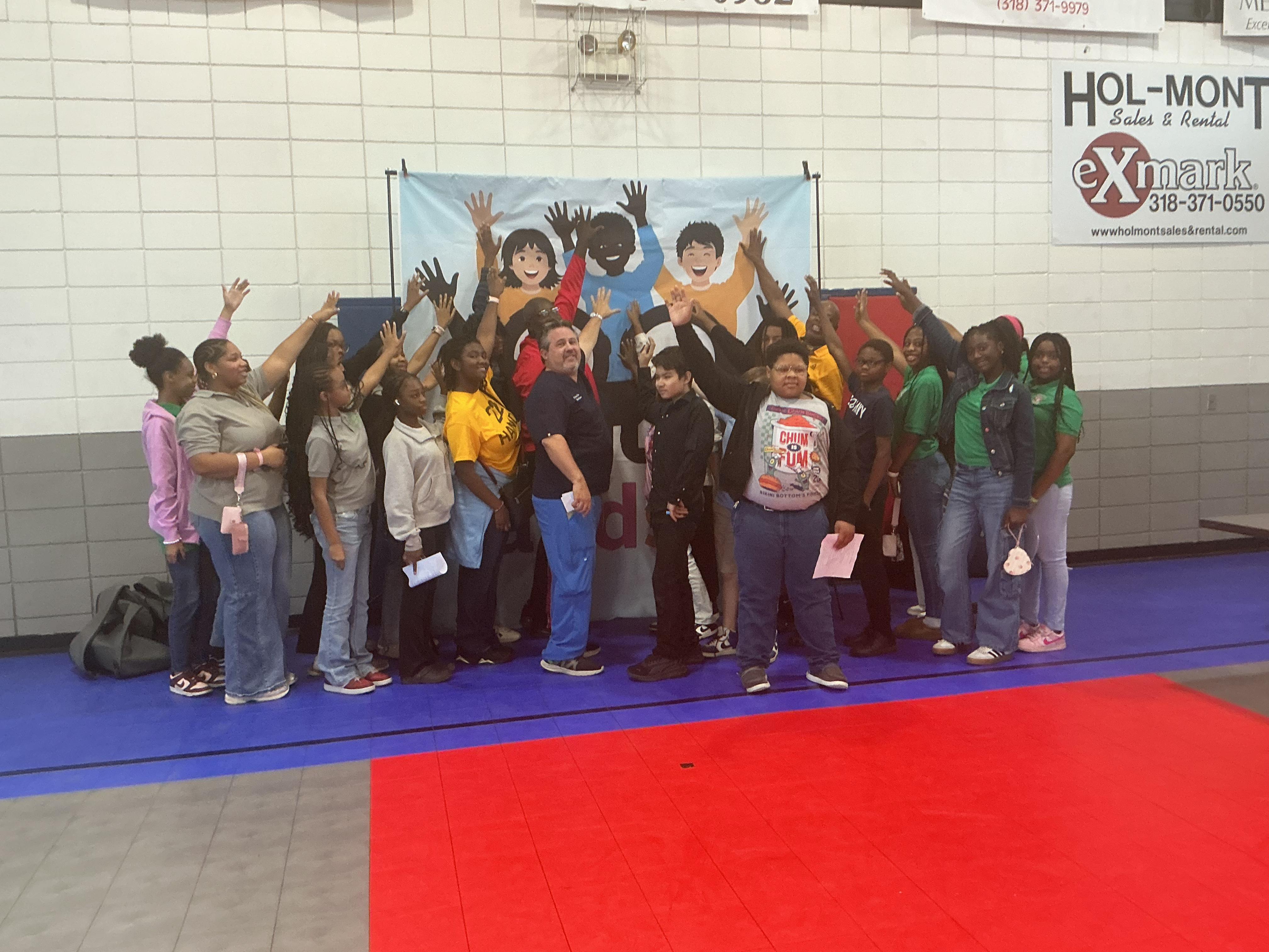 Youth group with hands raised